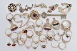 AN ASSORTMENT OF WHITE METAL JEWELLERY, to include three white metal fobs, an assortment of rings,