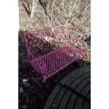 A PINK PAINTED WROUGHT IRON GARDEN BENCH, with floral decoration, length 114cm (condition:-