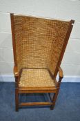 AN EARLY TO MID 20TH CENTURY OAK AND RUSH BACK ORKNEY CHAIR, with open armrests, width 55cm x