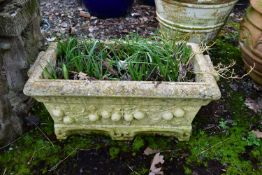 A WEATHERED COMPOSITE RECTANGULAR PLANTER, with floral decoration, length 67cm
