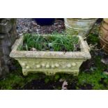 A WEATHERED COMPOSITE RECTANGULAR PLANTER, with floral decoration, length 67cm