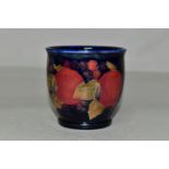A SMALL MOORCROFT POTTERY POMEGRANATE PLANTER, tube lined with pomegranates and berries on a navy