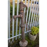 A WEATHERED CAST IRON WATER PUMP, on a reeded upright, height. 159cm (condition:- crack to lid,