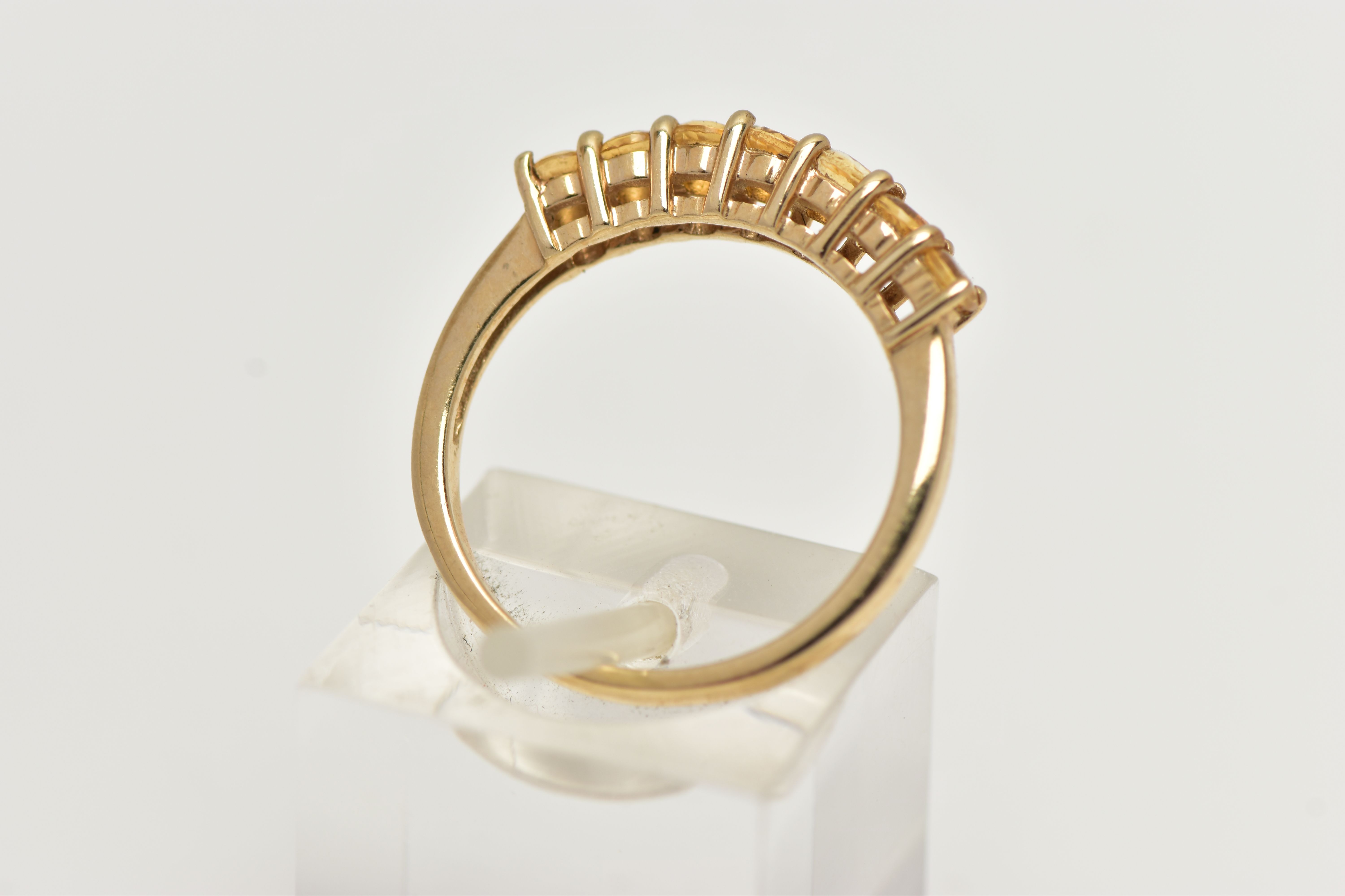 A 9CT GOLD CITRINE RING, designed with a row of seven circular cut citrines, to the polished band, - Image 3 of 4