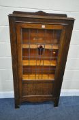 A 20TH CENTURY OAK LEAD GLAZED BOOKCASE, the single door with a central red stained glass flower