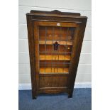 A 20TH CENTURY OAK LEAD GLAZED BOOKCASE, the single door with a central red stained glass flower