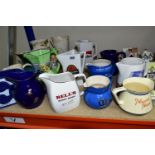 A COLLECTION OF TEN BREWERIANA WATER JUGS TOGETHER WITH COALPORT COTTAGES, comprising a Wade's '