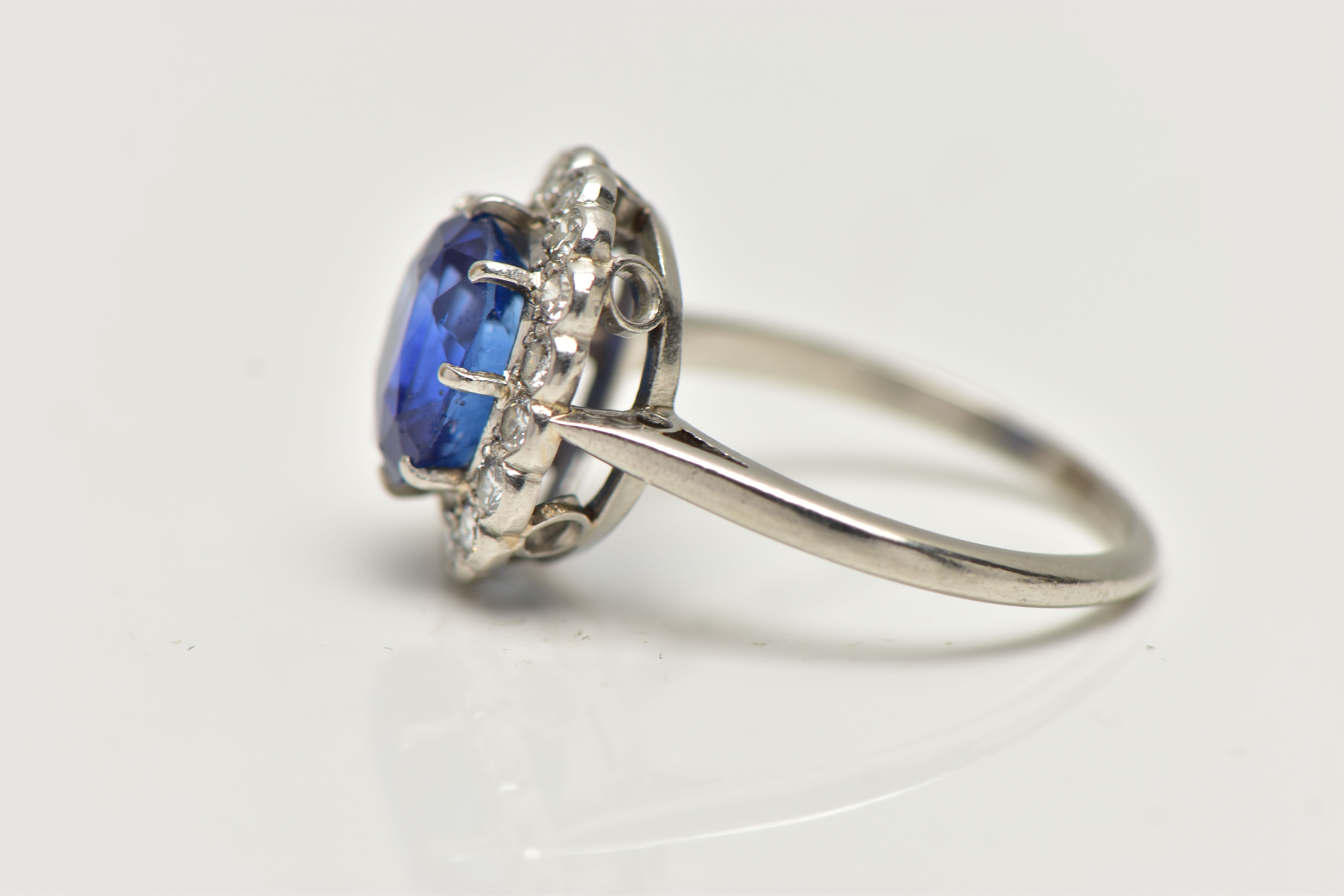 A SAPPHIRE AND DIAMOND CLUSTER RING, set with a mixed cut, cushion sapphire, measuring approximately - Image 8 of 13