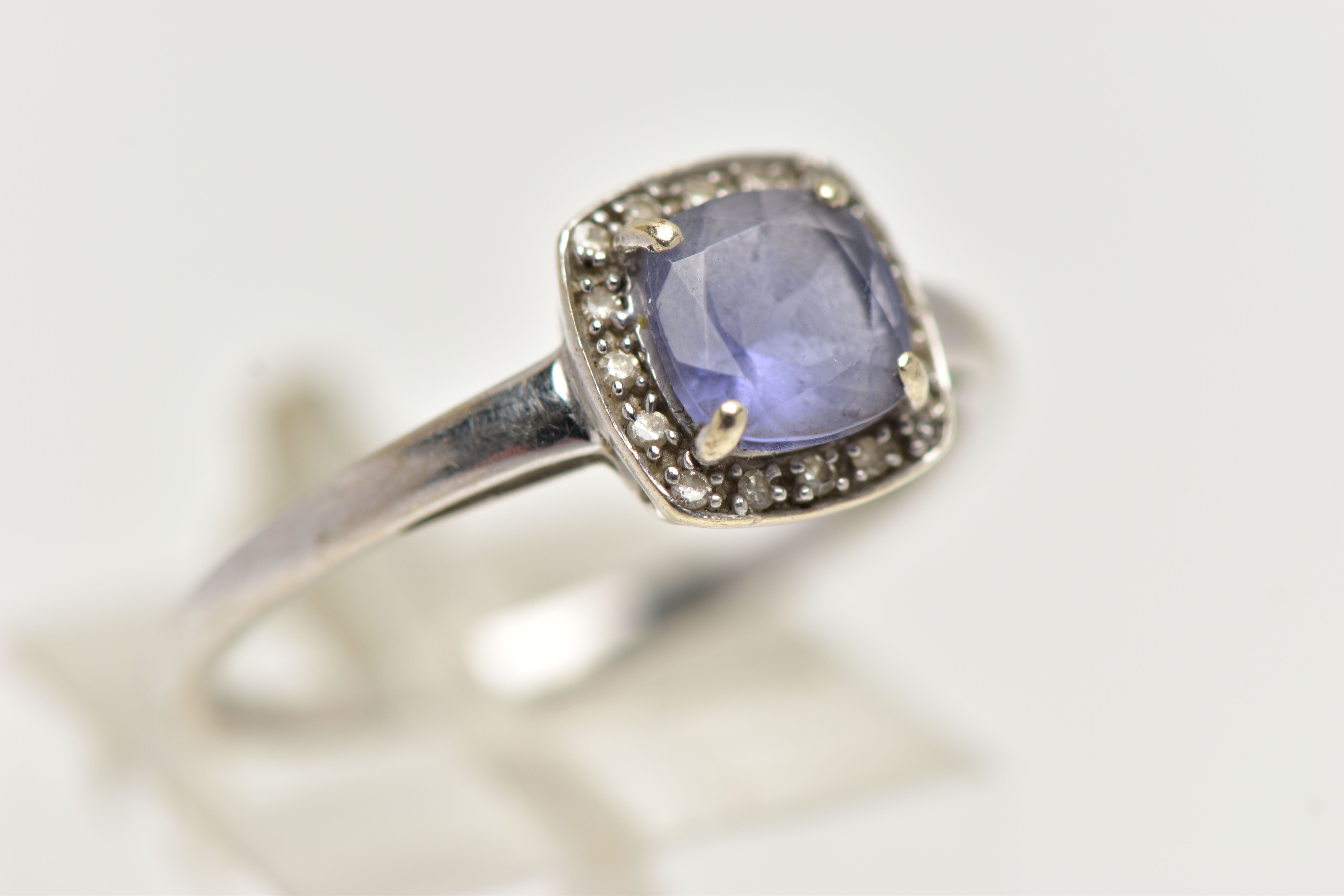 A WHITE METAL IOLITE AND DIAMOND CLUSTER RING, designed with a square cut iolite within a surround - Image 4 of 4