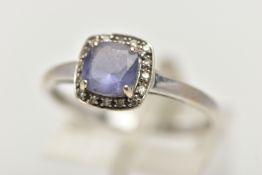 A WHITE METAL IOLITE AND DIAMOND CLUSTER RING, designed with a square cut iolite within a surround