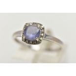 A WHITE METAL IOLITE AND DIAMOND CLUSTER RING, designed with a square cut iolite within a surround