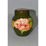 A MOORCROFT POTTERY SMALL GINGER JAR AND COVER, in the Coral Hibiscus pattern on a green ground,