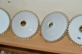 FOUR GLASS LAMPSHADES, each in white opaque glass with a clear wavy edge, slight variations in