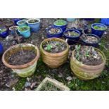 A PAIR OF WEATHERED TERRACOTTA PLANTERS, with floral design, diameter 50cm x height 43cm, and a