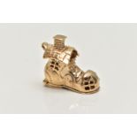 A 9CT GOLD CHARM, yellow gold charm of a boot house, fitted with a hinged sole, opens to reveal