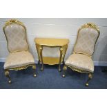 A PAIR OF GILT PAINTED FRENCH CHAIRS, with gold fabric, and a similar hall table, width 80cm x depth