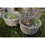 A PAIR OF WEATHERED COMPOSITE CIRCULAR PLANTERS, with a floral design, diameter 53cm x height