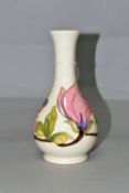 A MOORCROFT POTTERY MAGNOLIA VASE, of bottle form, decorated with tube lined pink Magnolia pattern