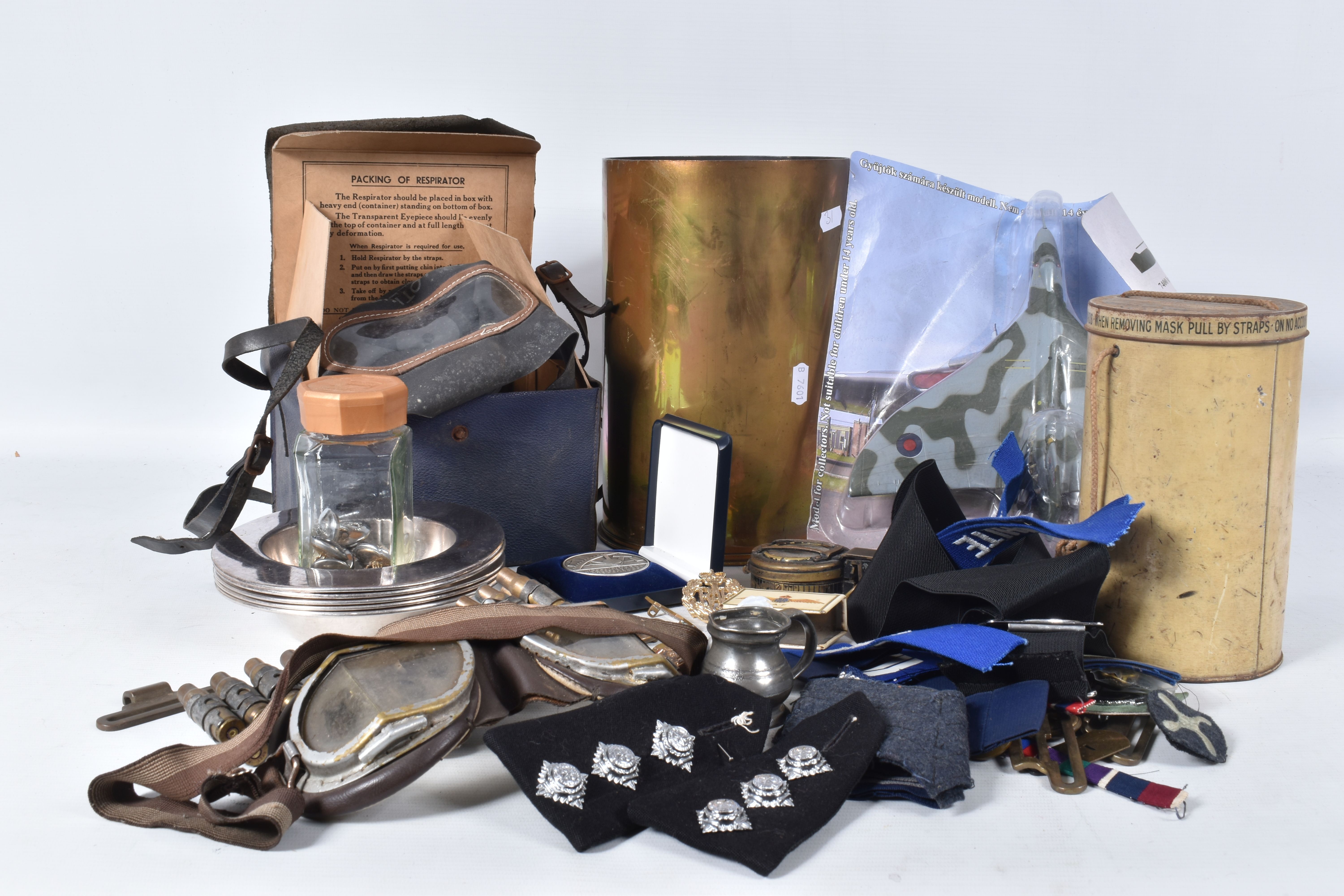 A BOX OF MIXED MILITARIA, to include a WWII compass, WWI trench art, gas masks, buttons, badges,