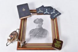 A SMALL BOX OF MILITARIA, to include a framed photo of a soldier in uniform, a new testament