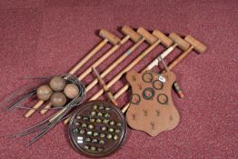 A CROQUET SET, with six wooden mallets, six metal hoops, two wooden pegs and four wooden balls, in