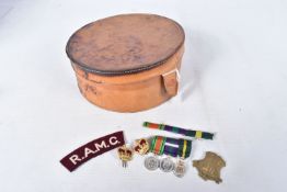 AN OFFICERS TERRATORIAL MINITURE MEDAL GROUP, two crowns, a RAMC shoulder title badge and a ribbon