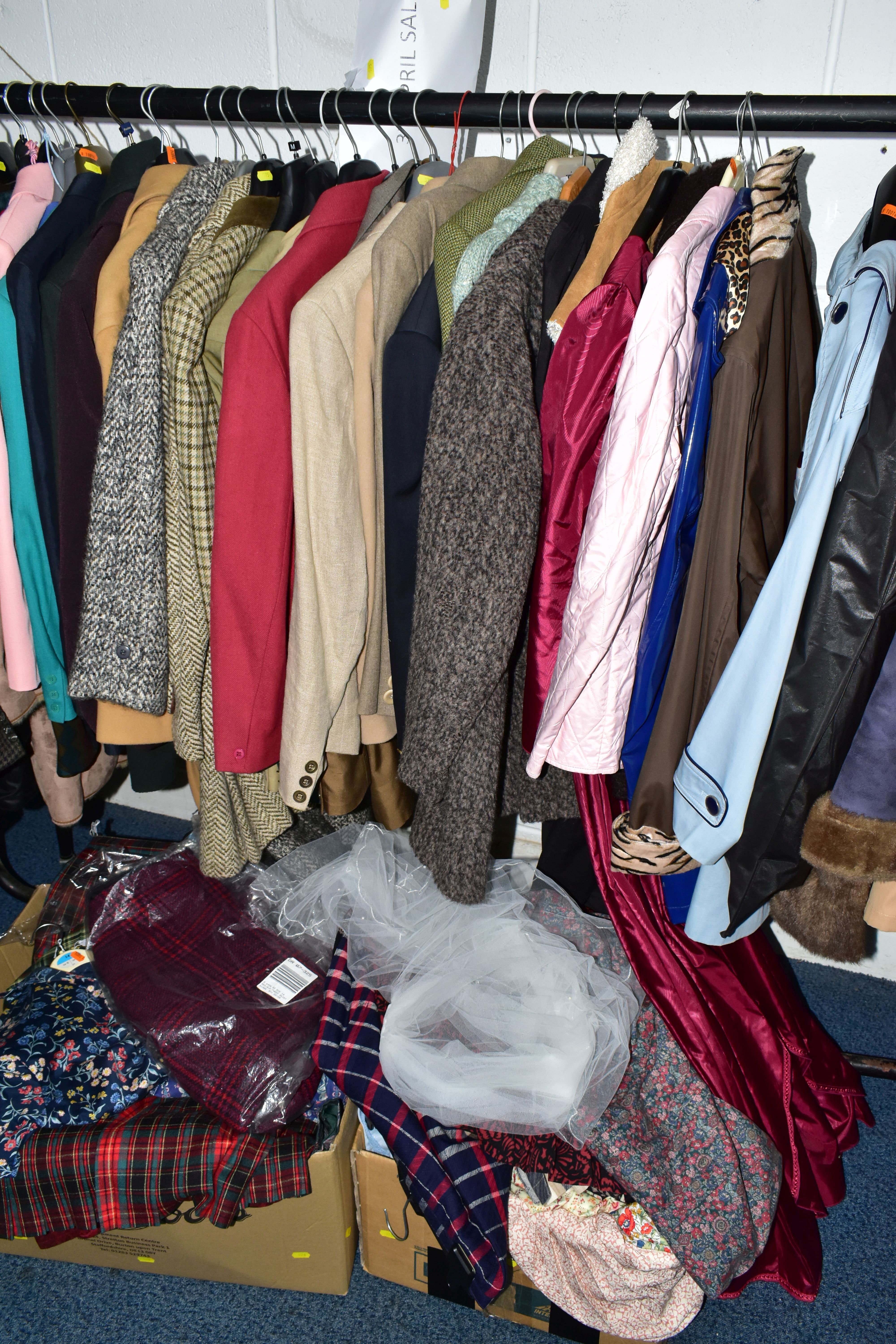 A RAIL AND TWO BOXES OF LADIES CLOTHING, to include coats, jackets, faux furs, sheepskins, skirts