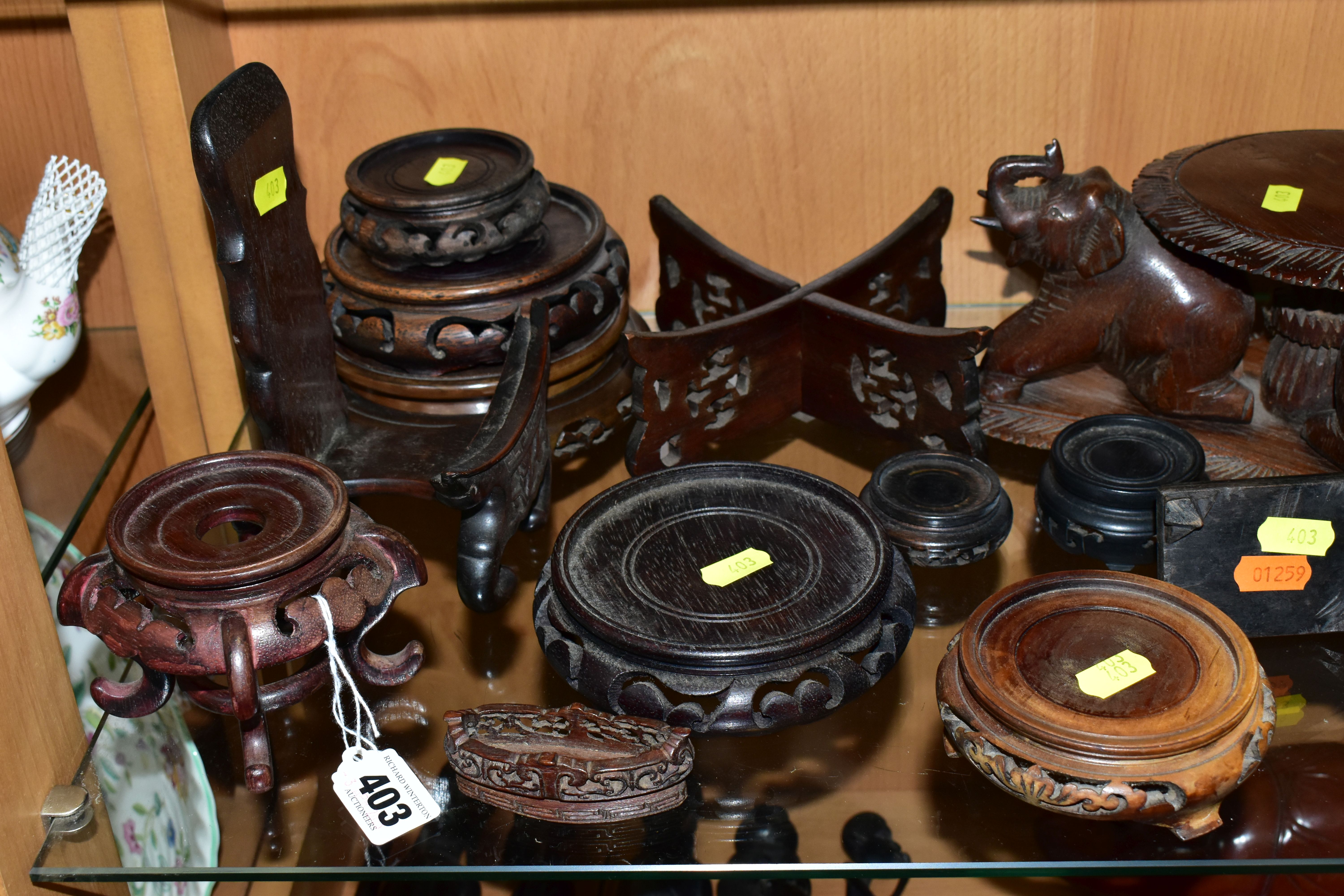 A QUANTITY OF WOODEN VASE STANDS, comprising an Arts & Crafts style tobacco jar with carved