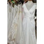 A GROUP OF NINE WEDDING DRESSES AND ONE PINK BRIDESMAID DRESS, retail stock clearance, varying UK