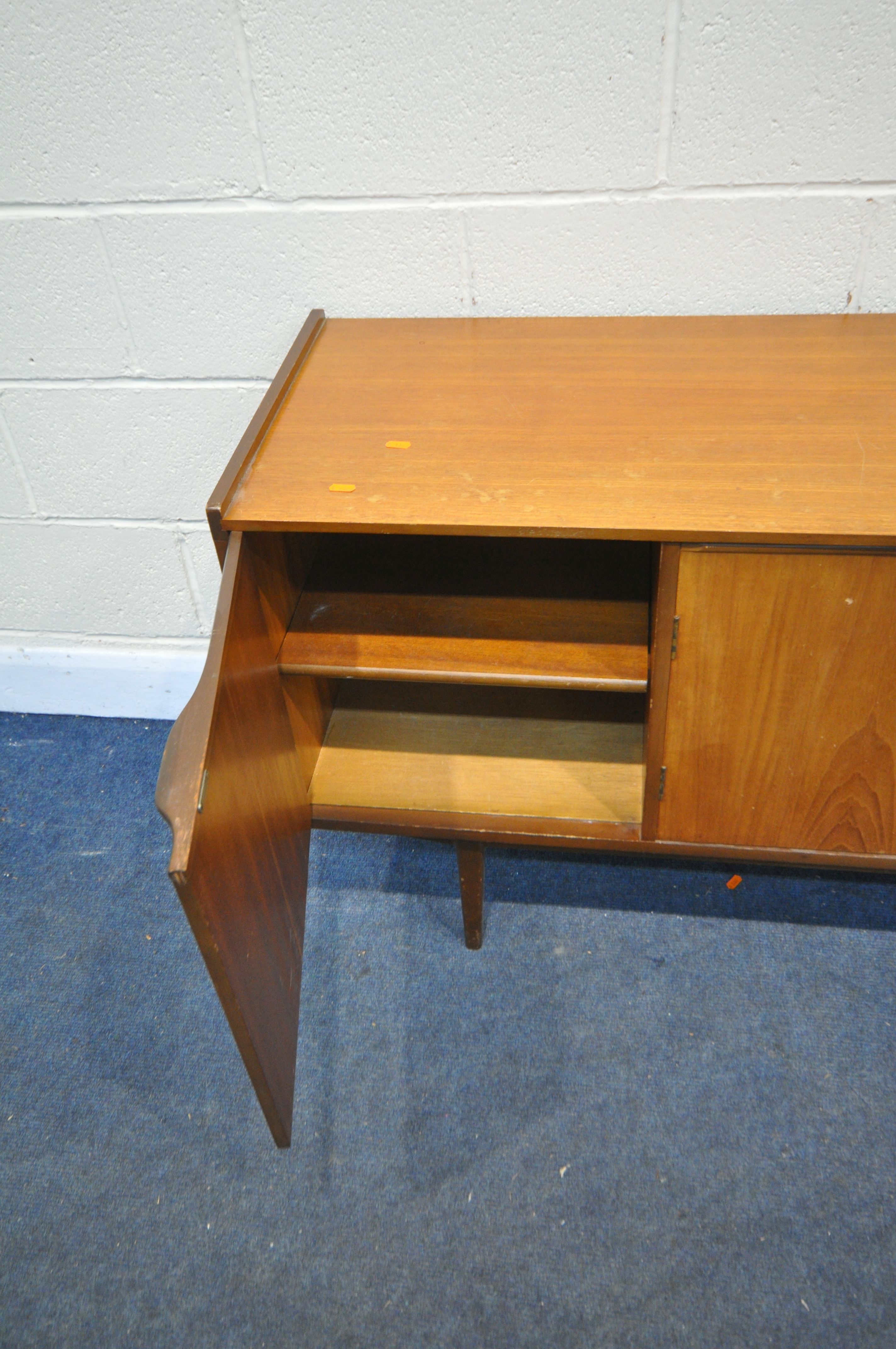 A MID CENTURY TEAK SIDEBOARD, with three cupboard doors and three drawers, on square tapering - Image 5 of 6