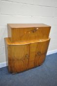 A SURELINE ART DECO STYLE WALNUT DRINKS CABINET, with a metamorphic fall front mirrored section,