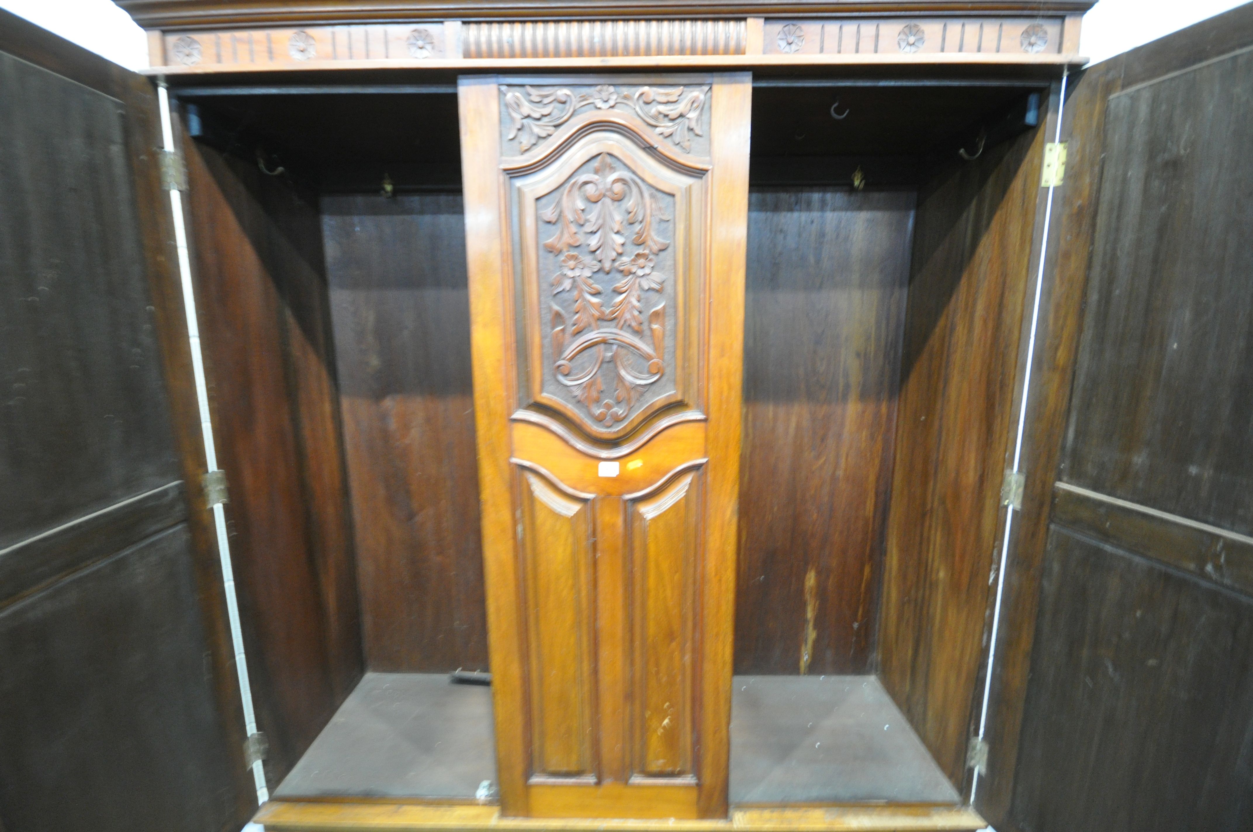 AN EDWARDIAN WALNUT WARDROBE, with two bevelled mirror doors that's flanking a fixed panel, over - Image 5 of 5