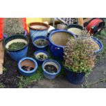 TWELVE BLUE GLAZED GARDEN PLANT POTS of differing sizes and styles the largest diameter being