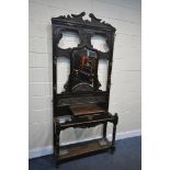 A LATE 19TH CENTURY CARVED OAK HALL STAND, with six brass coat hooks, central shaped bevelled edge