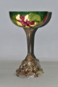 A MOORCROFT POTTERY BOWL DECORATED WITH RED AND YELLOW HIBISCUS ON A GREEN GROUND, the interior of