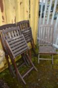 A SET OF FOUR DISTRESSED FOLDING CHAIRS with slatted wooden seats and backs (4)