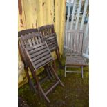 A SET OF FOUR DISTRESSED FOLDING CHAIRS with slatted wooden seats and backs (4)