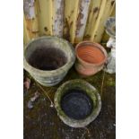 THREE COMPOSITE GARDEN PLANTERS the largest with ribbon and bow detail diameter 52cm, a wicker