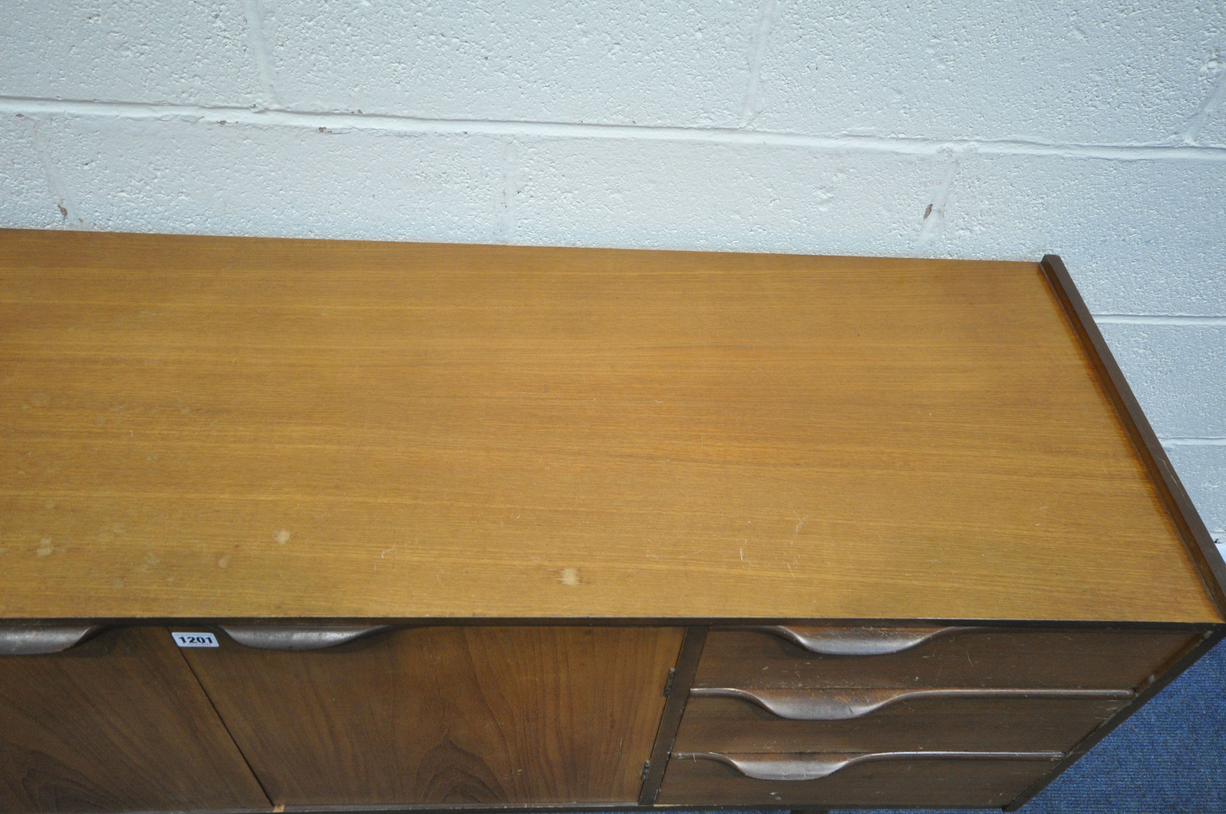 A MID CENTURY TEAK SIDEBOARD, with three cupboard doors and three drawers, on square tapering - Image 3 of 6