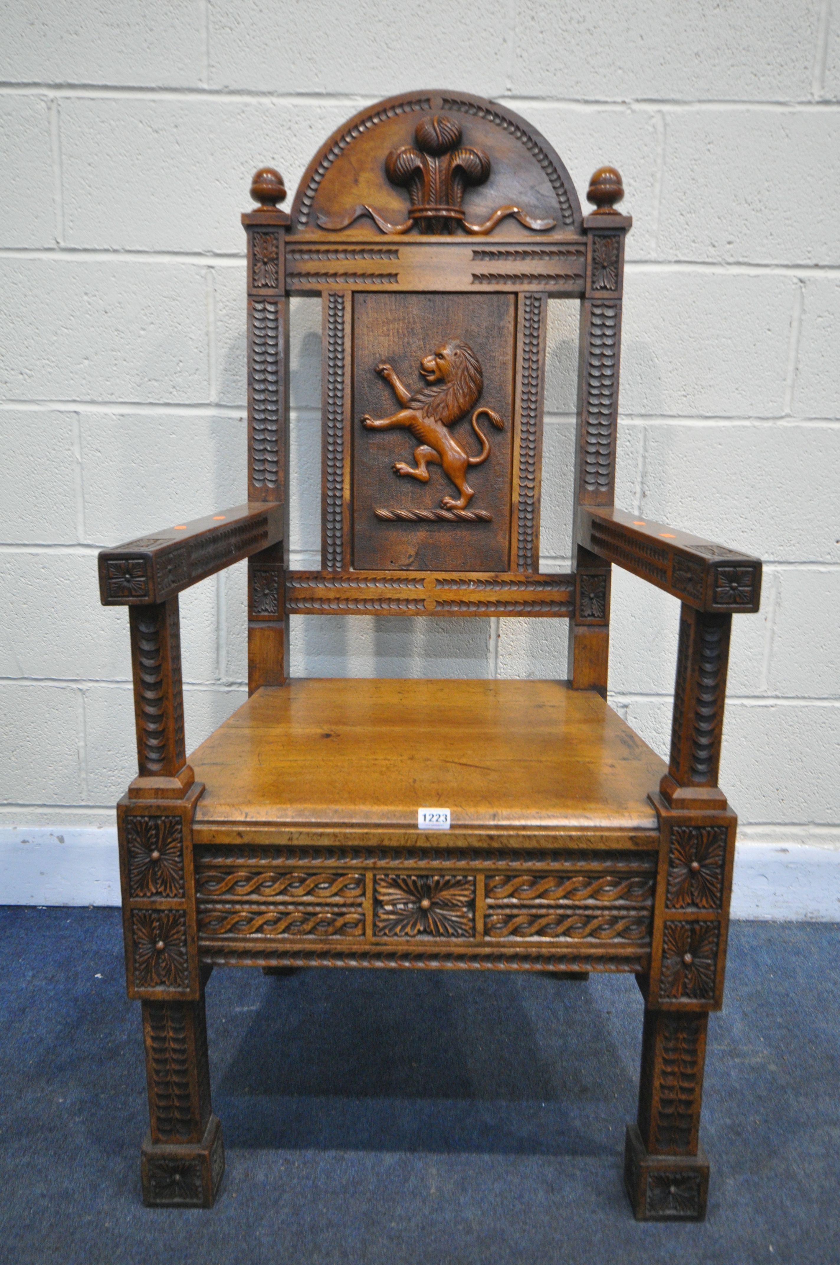 A LATE 19TH/ EARLY 20TH CENTURY CARVED OAK WAINSCOT CHAIR, the arched top depicting