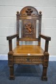 A LATE 19TH/ EARLY 20TH CENTURY CARVED OAK WAINSCOT CHAIR, the arched top depicting