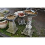 TWO MODERN COMPOSITE BIRD BATHS one with a tree stump style base, squirrel climbing, leaf and vine