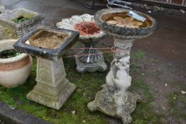 TWO MODERN COMPOSITE BIRD BATHS one with a tree stump style base, squirrel climbing, leaf and vine