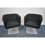 A PAIR OF BLACK UPHOLSTERED SWIVEL CHAIRS, on a metal base