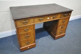 A 19TH CENTURY WALNUT PEDESTAL DESK, with a brown writing surface, and nine drawers, on casters,