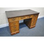 A 19TH CENTURY WALNUT PEDESTAL DESK, with a brown writing surface, and nine drawers, on casters,