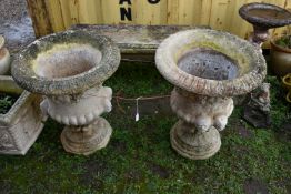 A PAIR OF MODERN COMPOSITE GARDEN URNS with a baluster bowl, face mask handles, grape and vine