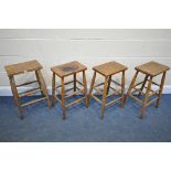 A SET OF FOUR BEECH LABRATORY STOOLS (condition:-distressed finish to all chairs)