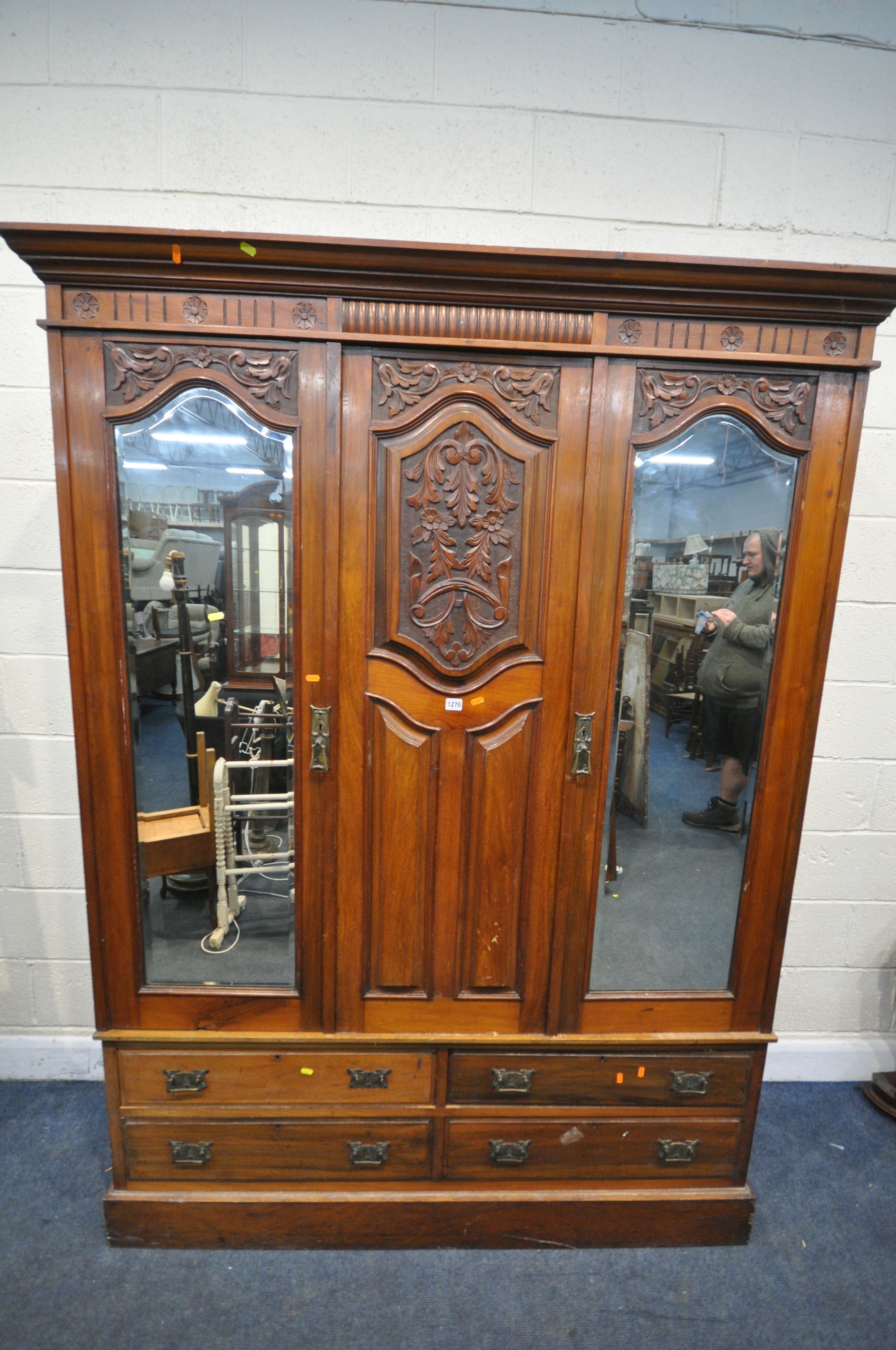 AN EDWARDIAN WALNUT WARDROBE, with two bevelled mirror doors that's flanking a fixed panel, over - Image 2 of 5