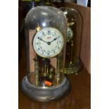 TWO BRASS ANNIVERSARY CLOCKS, comprising one with a glass dome mechanism marked 72632, with key (